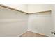 Interior of a walk-in closet featuring a wooden clothing rod with white supports at 2880 E Nunneley Rd, Gilbert, AZ 85296
