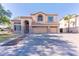 Two-story home with a three-car garage, neutral stucco, stone accents, and a well-manicured front lawn at 2880 E Nunneley Rd, Gilbert, AZ 85296