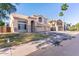 Charming two-story home with a three-car garage, neutral stucco, stone accents, and desert landscaping at 2880 E Nunneley Rd, Gilbert, AZ 85296