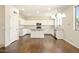 Bright kitchen with white cabinets, stainless steel appliances, large windows, and an island for meal prep at 2880 E Nunneley Rd, Gilbert, AZ 85296