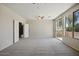 Bright living room with plush carpet, natural light, and access to a patio at 2880 E Nunneley Rd, Gilbert, AZ 85296