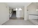 Bright living room with chandelier and stairway access at 2880 E Nunneley Rd, Gilbert, AZ 85296