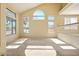 Bright living room featuring vaulted ceilings, a railing to upstairs, and lots of natural light at 2880 E Nunneley Rd, Gilbert, AZ 85296