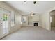Spacious living room with fireplace, built-ins, and backyard access at 2880 E Nunneley Rd, Gilbert, AZ 85296