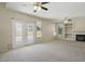Spacious living room with fireplace, built-ins, and double doors at 2880 E Nunneley Rd, Gilbert, AZ 85296