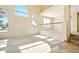 Bright living room featuring vaulted ceilings, a railing to upstairs, lots of natural light, and tile/carpet flooring at 2880 E Nunneley Rd, Gilbert, AZ 85296