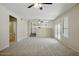 Bright living room featuring neutral walls, plush carpet, ceiling fans, and natural light streaming through windows at 2880 E Nunneley Rd, Gilbert, AZ 85296