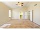 Spacious carpeted primary bedroom with ceiling fan, two closets and windows at 2880 E Nunneley Rd, Gilbert, AZ 85296