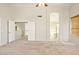 Large carpeted primary bedroom with vaulted ceilings and archway to bathroom at 2880 E Nunneley Rd, Gilbert, AZ 85296