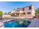 Home's backyard featuring a clean pool, view of the house, and grassy area at 2880 E Nunneley Rd, Gilbert, AZ 85296