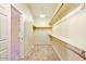 A carpeted walk-in closet featuring shelving and rod for organized storage at 2880 E Nunneley Rd, Gilbert, AZ 85296