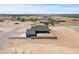 An aerial view of a home with large lot surrounded by green fields in the distance at 300 S Charleston Ct, Casa Grande, AZ 85194