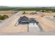 Aerial view of a home with a detached garage, block wall and large lot at 300 S Charleston Ct, Casa Grande, AZ 85194