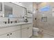 Bright bathroom featuring marble tile, a black framed mirror, and vanity with storage at 300 S Charleston Ct, Casa Grande, AZ 85194