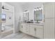 Modern bathroom featuring double vanity with marble countertops and decorative mirrors offering a bright space at 300 S Charleston Ct, Casa Grande, AZ 85194