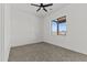 This is a bedroom with carpet, ceiling fan, and a window with a view of the outdoors at 300 S Charleston Ct, Casa Grande, AZ 85194