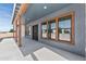 Inviting covered entryway featuring sleek double doors, natural wood pillars, and stylish windows at 300 S Charleston Ct, Casa Grande, AZ 85194