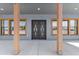 Welcoming covered entryway featuring modern double doors, natural wood pillars, and ample lighting at 300 S Charleston Ct, Casa Grande, AZ 85194