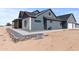 Side view of the home showing siding, rock details, and three car garage at 300 S Charleston Ct, Casa Grande, AZ 85194