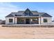 Charming single-story home featuring stone accents, a symmetrical design and a welcoming front porch at 300 S Charleston Ct, Casa Grande, AZ 85194