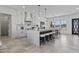 Bright, open kitchen with white cabinets, a large island with seating, and stainless steel appliances at 300 S Charleston Ct, Casa Grande, AZ 85194