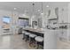 Bright kitchen featuring white cabinets, quartz countertops, pendant lighting, and stainless steel appliances at 300 S Charleston Ct, Casa Grande, AZ 85194