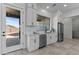 Modern kitchen with white cabinets, stainless steel appliances, and a view to the backyard at 300 S Charleston Ct, Casa Grande, AZ 85194