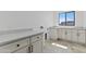Bright laundry room with white cabinetry, stylish countertops, and tile flooring offers functional elegance at 300 S Charleston Ct, Casa Grande, AZ 85194