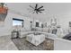 Large living room with oversized sectional couch, ceiling fan, and access to the kitchen at 300 S Charleston Ct, Casa Grande, AZ 85194