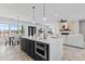 Open-concept living room and kitchen with a large island, fireplace, and dining area at 300 S Charleston Ct, Casa Grande, AZ 85194