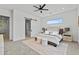 Stylish bedroom with a ceiling fan, carpet flooring, and a large window showcasing scenic outdoors at 300 S Charleston Ct, Casa Grande, AZ 85194