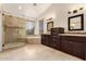Luxurious bathroom featuring a glass-enclosed shower and a soaking tub with natural light at 3132 E Wildwood Dr, Phoenix, AZ 85048