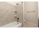 Bathroom with tiled shower-tub combo, bronze fixtures, and neutral decor at 3132 E Wildwood Dr, Phoenix, AZ 85048