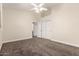 Spacious bedroom featuring soft carpet, white walls, ceiling fan and closet at 3132 E Wildwood Dr, Phoenix, AZ 85048