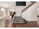 Bright foyer featuring beautiful hardwood floors and staircase with mosaic details at 3132 E Wildwood Dr, Phoenix, AZ 85048