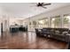 Bright, open-concept living room with hardwood floors that flows into an updated kitchen at 3132 E Wildwood Dr, Phoenix, AZ 85048