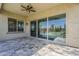 Covered patio with ceiling fan overlooks a backyard featuring turf and a gated pool, perfect for outdoor living at 3310 E Los Gatos Dr, Phoenix, AZ 85050