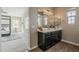 Bathroom with dark cabinets, double vanity, and access to the main bedroom at 3310 E Los Gatos Dr, Phoenix, AZ 85050