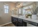 Bathroom with dark cabinets, dual sinks, and decorative lighting at 3310 E Los Gatos Dr, Phoenix, AZ 85050