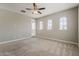 Light-filled bedroom with carpet, a ceiling fan, and access to a private balcony at 3310 E Los Gatos Dr, Phoenix, AZ 85050