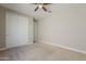 Cozy bedroom with generous closet space and a ceiling fan, perfect for rest and relaxation at 3310 E Los Gatos Dr, Phoenix, AZ 85050