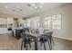 Spacious dining room showcasing modern lighting and easy access to kitchen at 3310 E Los Gatos Dr, Phoenix, AZ 85050