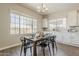 Dining room features modern table, chairs, chandelier, and lots of natural light at 3310 E Los Gatos Dr, Phoenix, AZ 85050