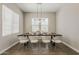 Inviting dining room with modern decor, stylish lighting, and hardwood floors at 3310 E Los Gatos Dr, Phoenix, AZ 85050