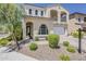 Beautiful home with an arched entryway, manicured landscaping, and a paver driveway at 3310 E Los Gatos Dr, Phoenix, AZ 85050