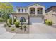Charming two-story home with a balcony, arched windows and a well-manicured front yard at 3310 E Los Gatos Dr, Phoenix, AZ 85050