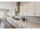 Kitchen featuring white cabinets, stainless hood, gray subway tile, and gas cooktop at 3310 E Los Gatos Dr, Phoenix, AZ 85050