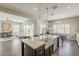 Open concept kitchen and living room showcasing natural light, and stainless steel appliances at 3310 E Los Gatos Dr, Phoenix, AZ 85050