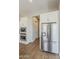 Bright kitchen features stainless steel refrigerator and white cabinets for a modern look at 3310 E Los Gatos Dr, Phoenix, AZ 85050