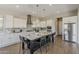 Kitchen featuring large island with seating, stainless appliances, white cabinets, and gray subway tile backsplash at 3310 E Los Gatos Dr, Phoenix, AZ 85050